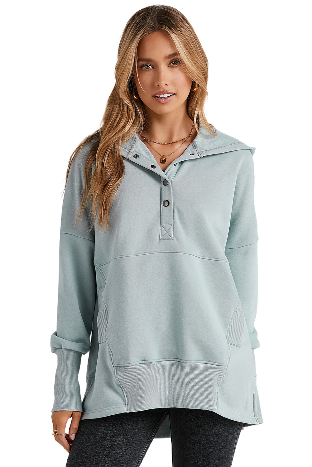 A person with long hair is smiling and looking over their shoulder while wearing a Gray Batwing Sleeve Pocketed Henley Hoodie.