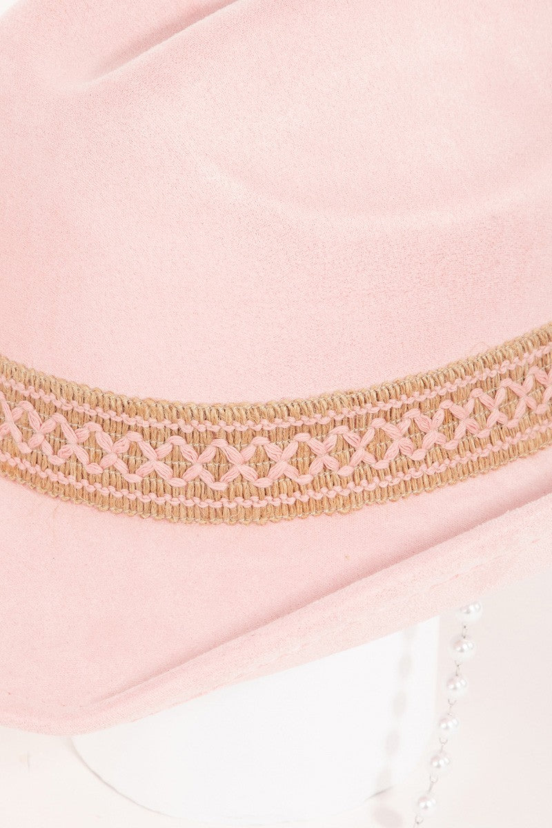 Fame Ornate Band Cowboy Hat in light pink features an intricate band around the crown and a pearl chain elegantly draped from the side, offering a distinctive look.