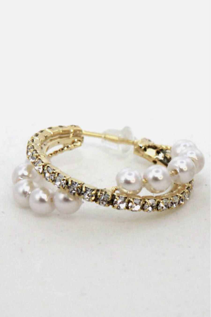 Alloy Pearl Hoop Earrings featuring gold hoops with imitation pearls and small clear gemstones, showcased on a vertical stand.