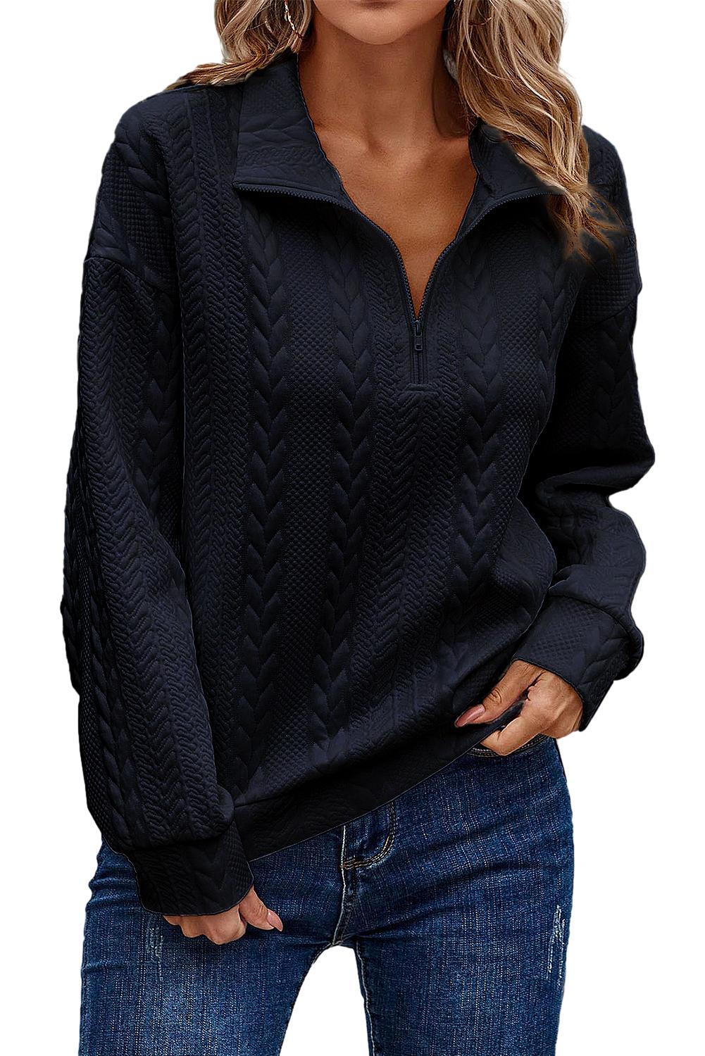 A person wearing a Navy Blue Zip Up Cable Textured Sweatshirt and blue jeans, seen from the back, standing on an urban street.
