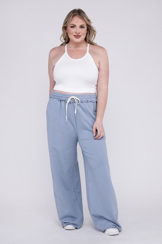 A person wearing the Plus F/Terry Drawstring Waist Raw Edge Hem Pants in pink, paired with white shoes, stands against a plain background.