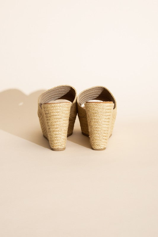 A pair of Bounty-S Wedge Platform Heels featuring a beige woven straw-like texture, open toe straps, and brown insoles.