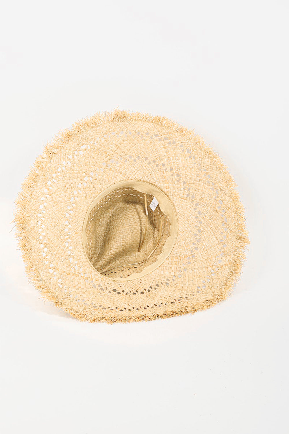 The Fame Openwork Raw Hem Weave Hat, with its wide brim and natural straw material featuring intricate openwork woven patterns, lies flat on a white background, making it the perfect chic summer accessory.