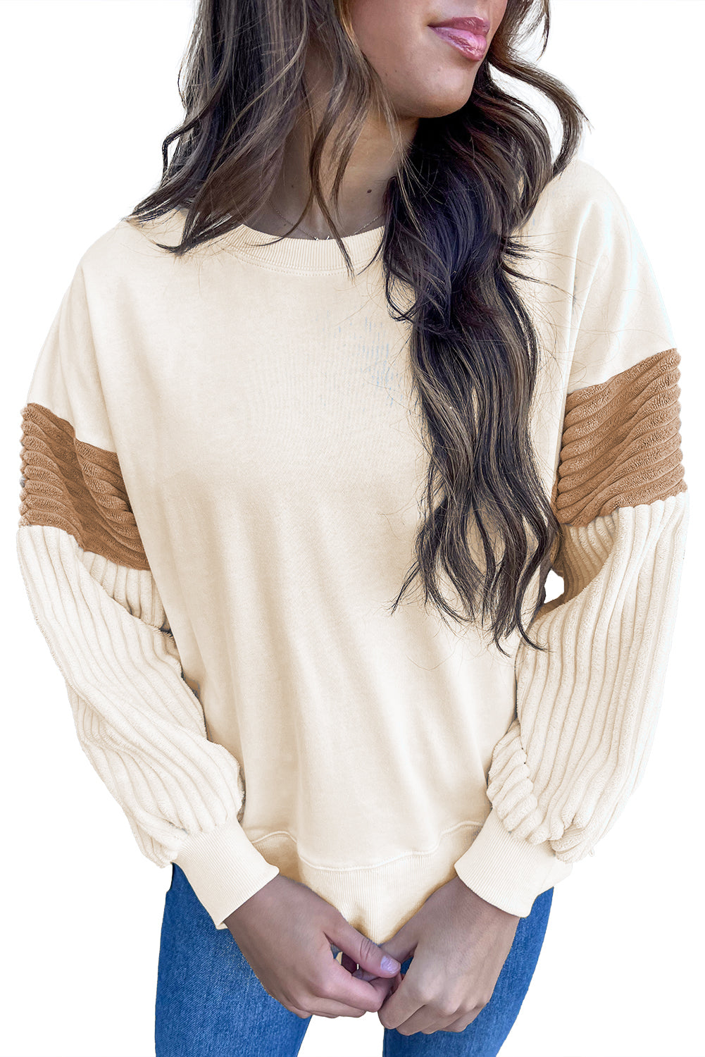 A person with long hair is wearing an Apricot Corduroy Patchwork Drop Shoulder Long Sleeve Sweatshirt, standing with their back to the camera against a light blue corrugated metal wall.