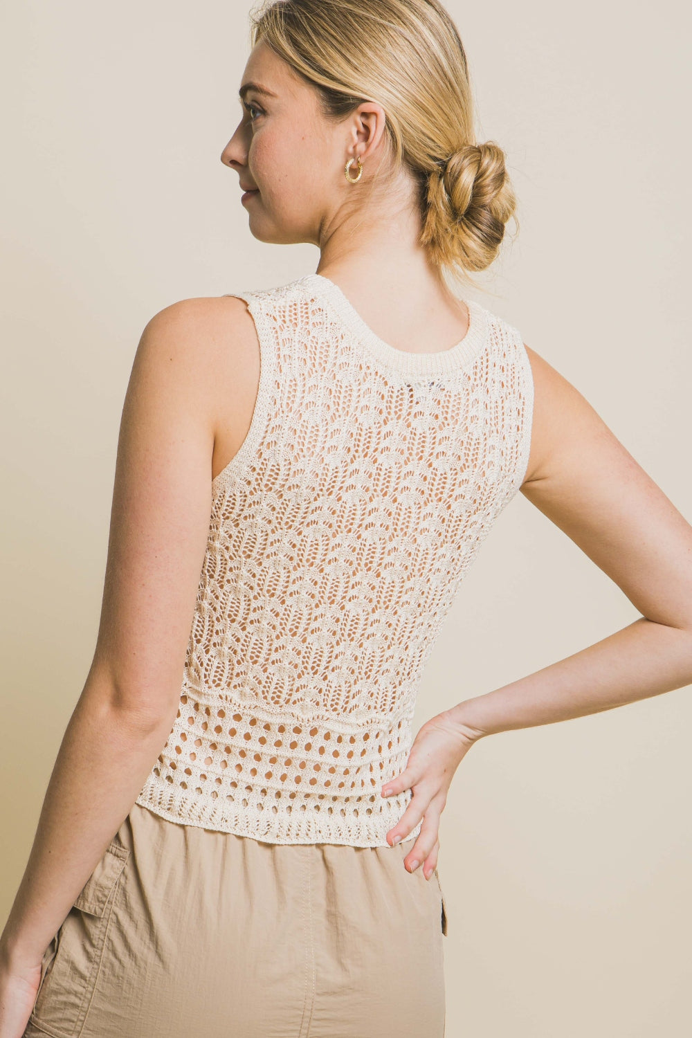 A woman wears the Love Tree Contrast Line Openwork Knit Tank, paired with beige cargo pants, against a plain background.