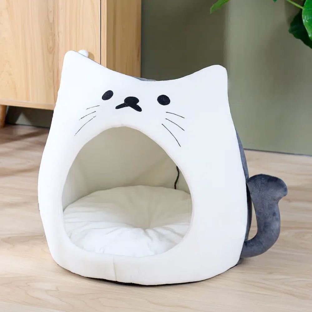 An Adorable Cat Shape Pet House nestled in a cozy pet house designed like a cat shape bed, enjoying the soft spot.