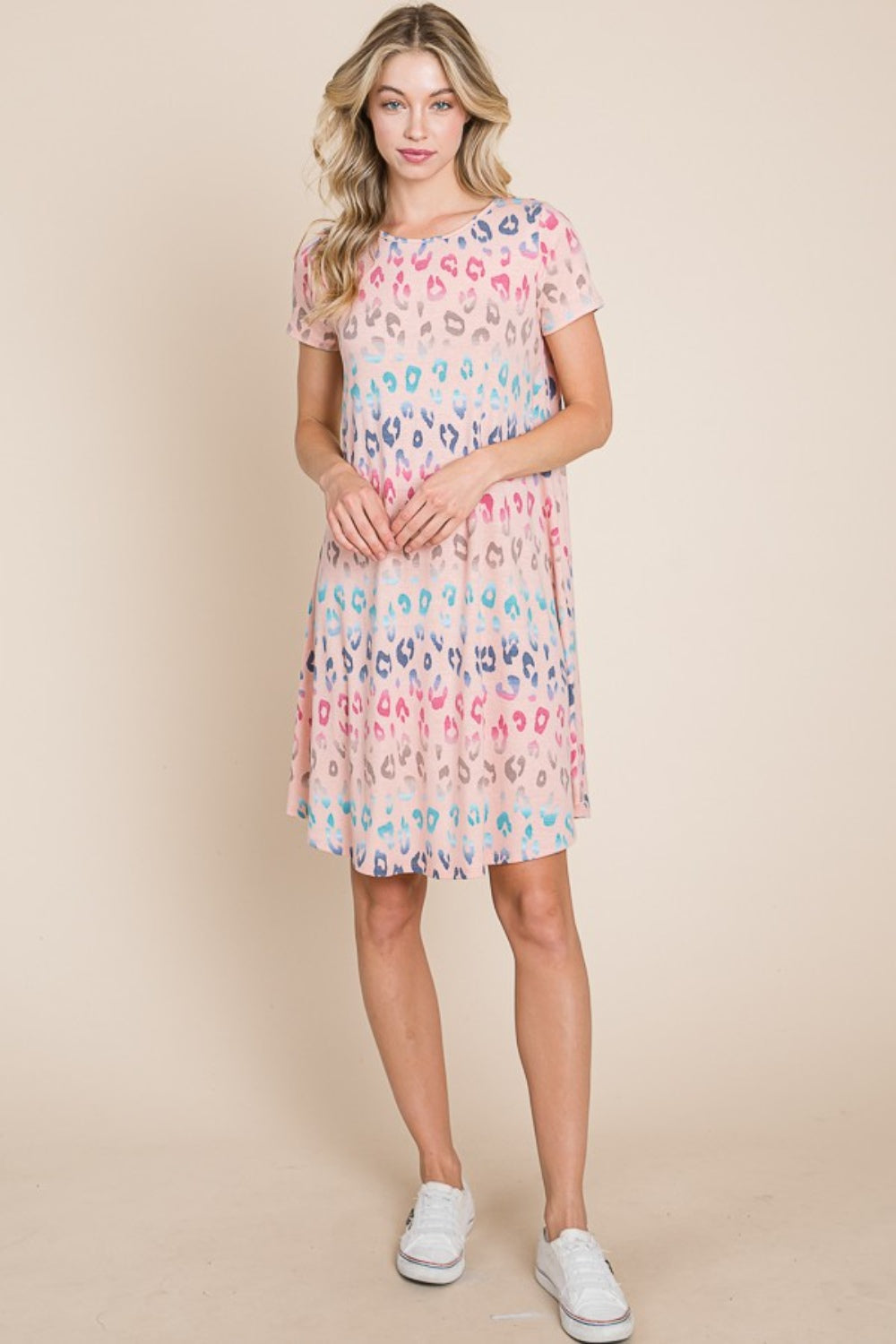 A woman wearing the BOMBOM Leopard Round Neck Short Sleeve Dress and a straw hat poses against a beige background.