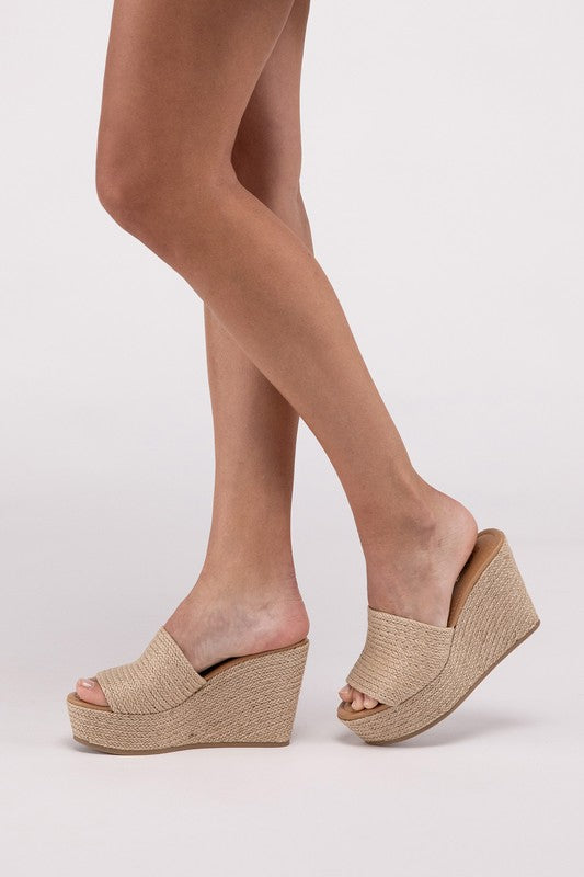 A pair of Bounty-S Wedge Platform Heels featuring a beige woven straw-like texture, open toe straps, and brown insoles.
