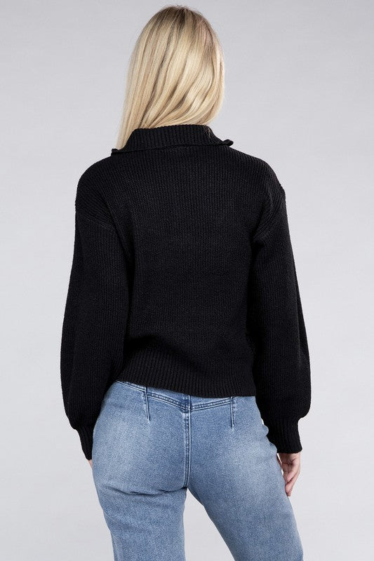 A person with long blonde hair wears a stylish cozy top—an Easy-Wear Half-Zip Pullover in grey—and blue jeans while looking down.