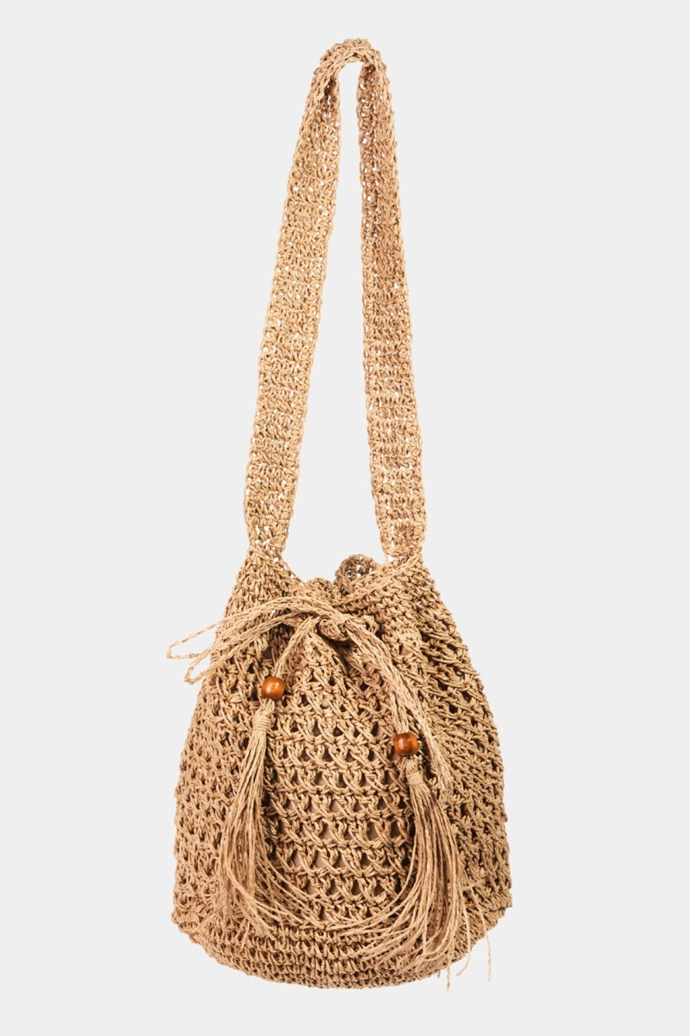 Fame Straw Braided Drawstring Tote Bag with Tassel in beige, highlighted by its crochet-like texture and a practical drawstring closure.