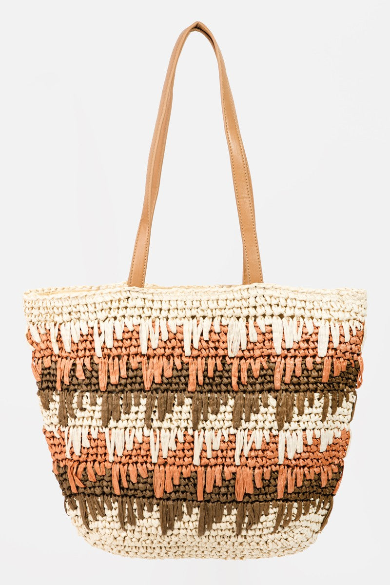 A Fame Straw Braided Striped Tote Bag featuring tan handles and a checkered pattern in cream, brown, and terracotta colors.