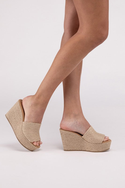 A pair of Bounty-S Wedge Platform Heels featuring a beige woven straw-like texture, open toe straps, and brown insoles.