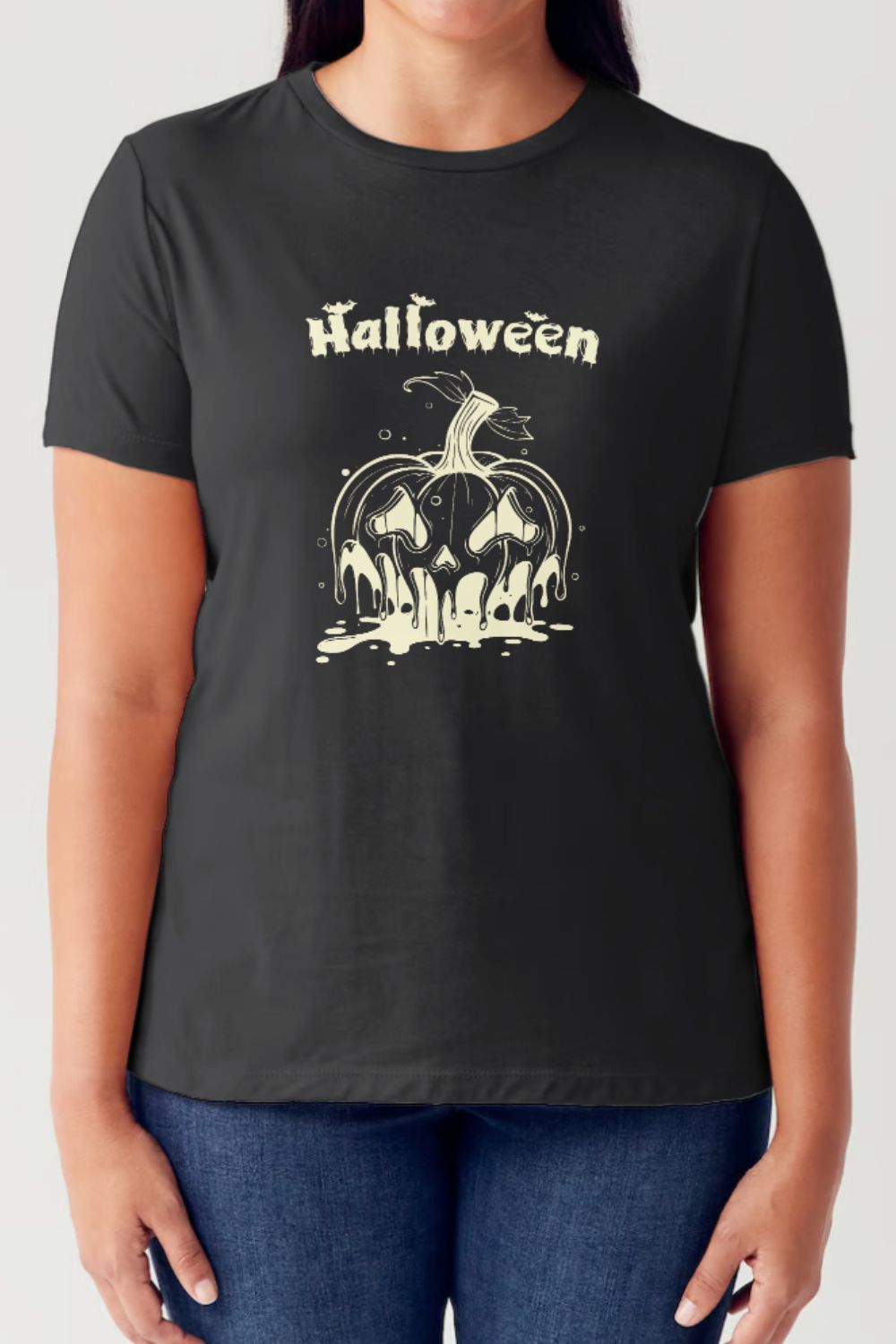 A person wears a Simply Love Full Size HALLOWEEN Short Sleeve Tubular T-Shirt featuring a festive graphic depicting a melting pumpkin with the word "Halloween" printed above it. Complementing their fun and breathable fabric choice, they are also sporting blue jeans.