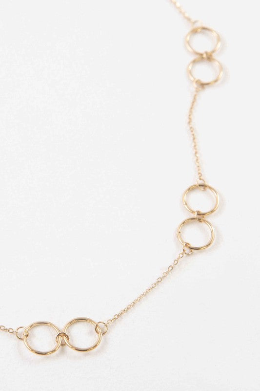 The Double Double Necklace is adorned with interlinked circular designs made from 14k gold-plated stainless steel and fastens with a lobster clasp.