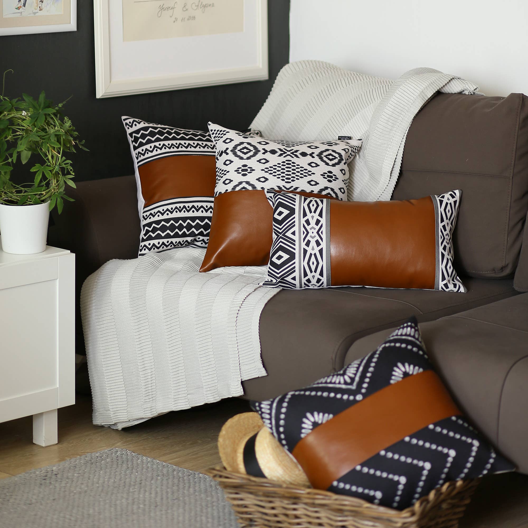 A Bohemian Handmade Decorative Single Throw Pillow featuring a vegan faux leather brown stripe and geometric ivory patterns, set against a beige textured blanket.