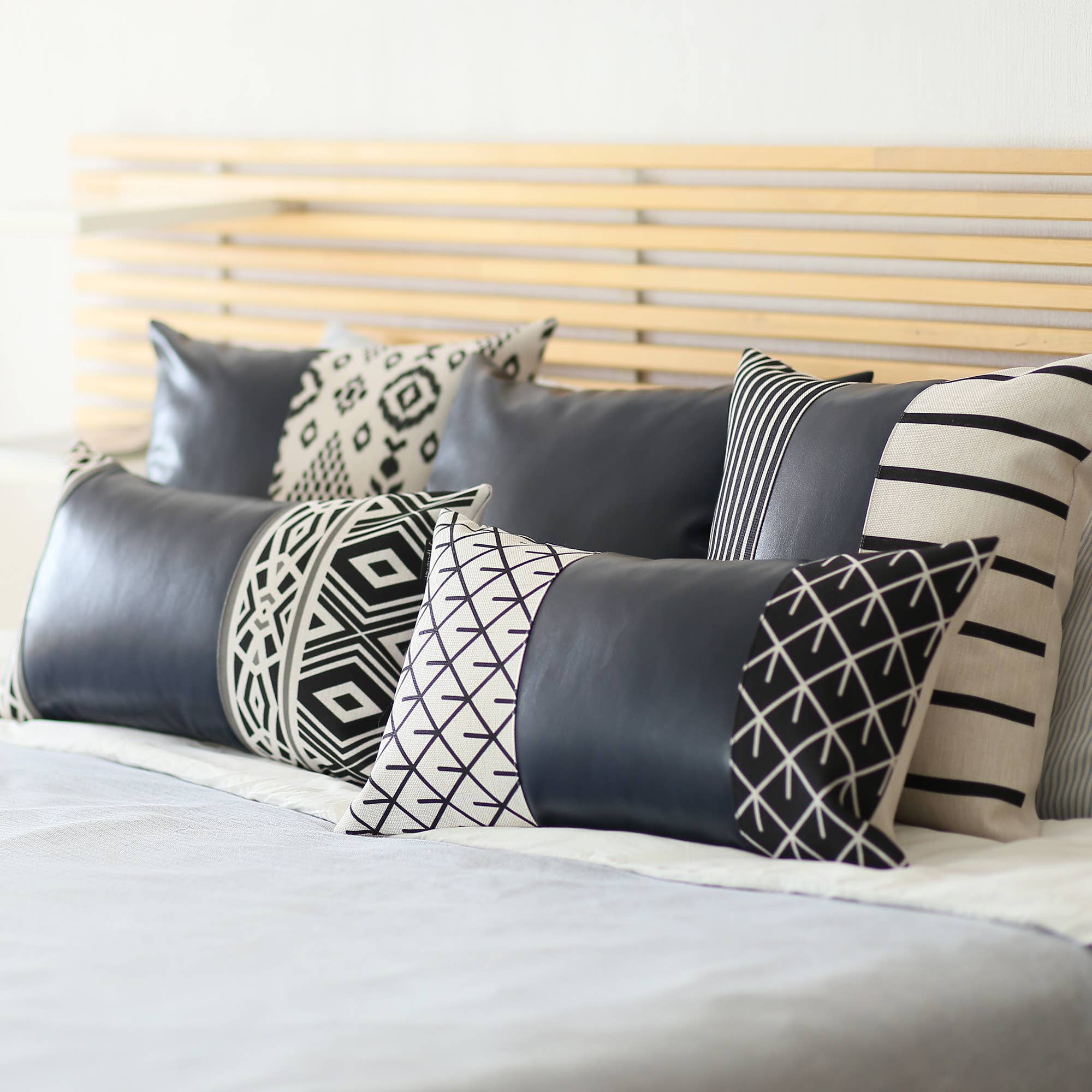 Resting on a yellow cushion is the Bohemian Handmade Decorative Single Throw Pillow, featuring vegan faux leather with a geometric pattern on one half. The setup is completed with round lights draped over it, showcasing the eclectic charm of bohemian throw pillows.