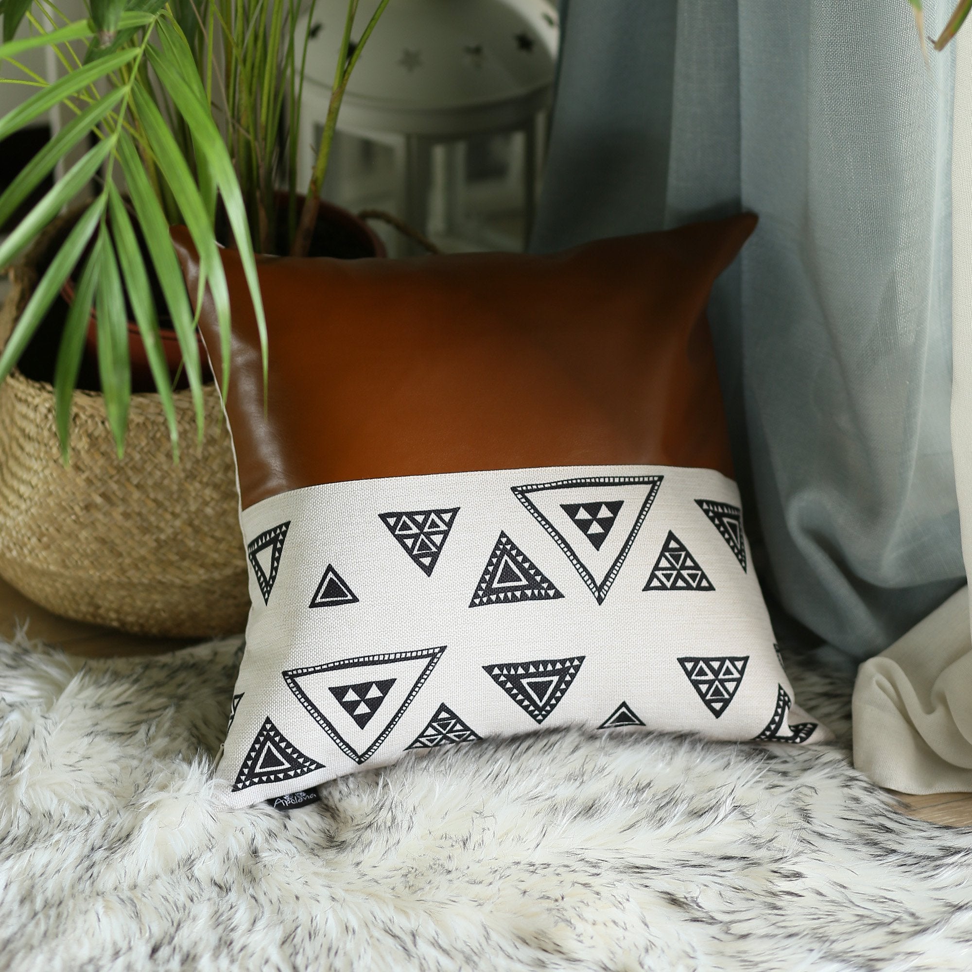 Resting on a yellow cushion is the Bohemian Handmade Decorative Single Throw Pillow, featuring vegan faux leather with a geometric pattern on one half. The setup is completed with round lights draped over it, showcasing the eclectic charm of bohemian throw pillows.