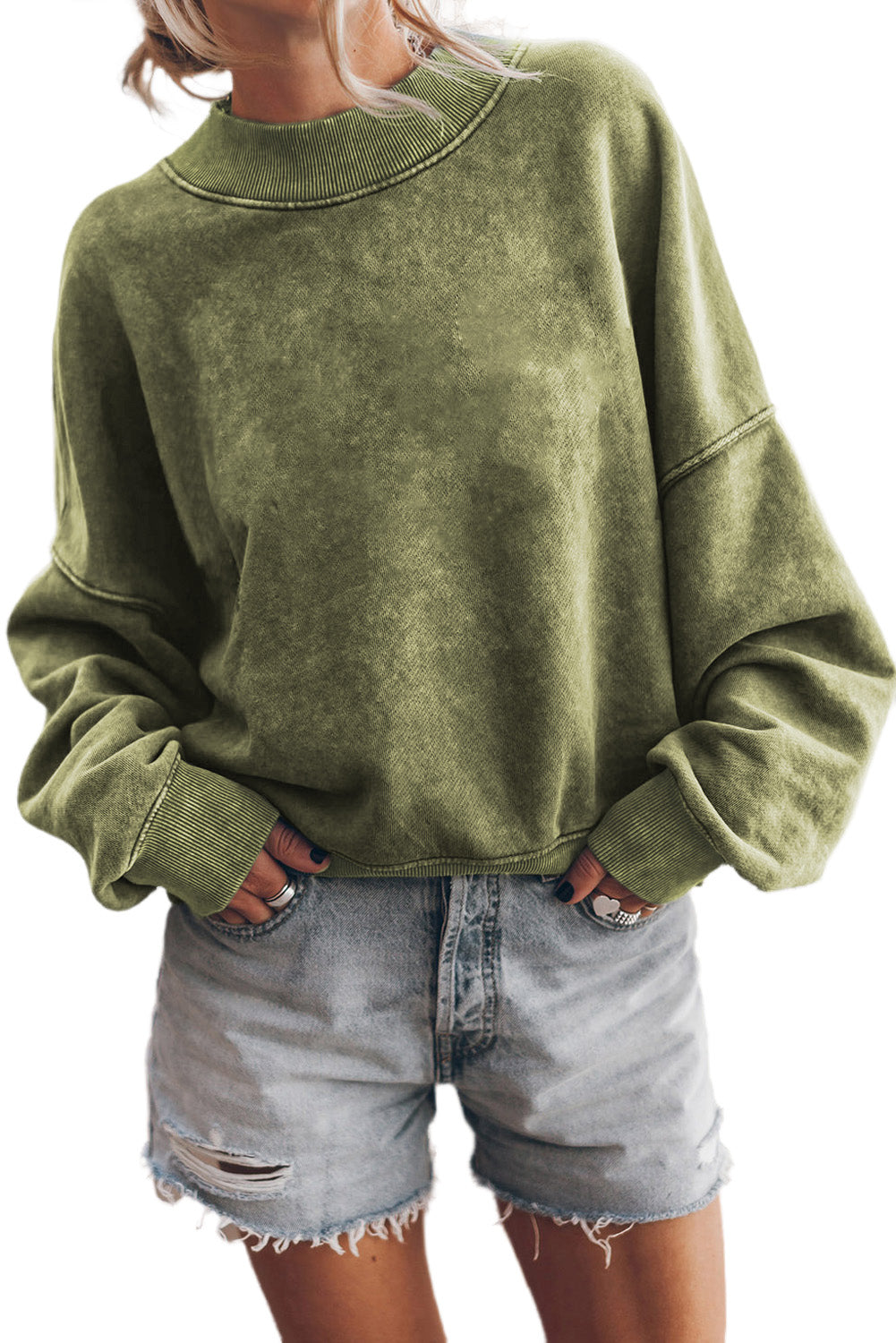 Person wearing a Green Drop Shoulder Crew Neck Pullover Sweatshirt with rolled-up sleeves, grey jeans, and bracelets. Their hand is in their pocket.