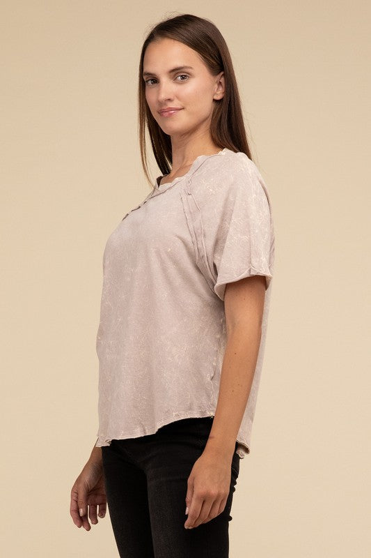 A person with long brown hair wearing a Back Patch Crinkle Washed Raglan Sleeve T-Shirt stands against a plain beige background.