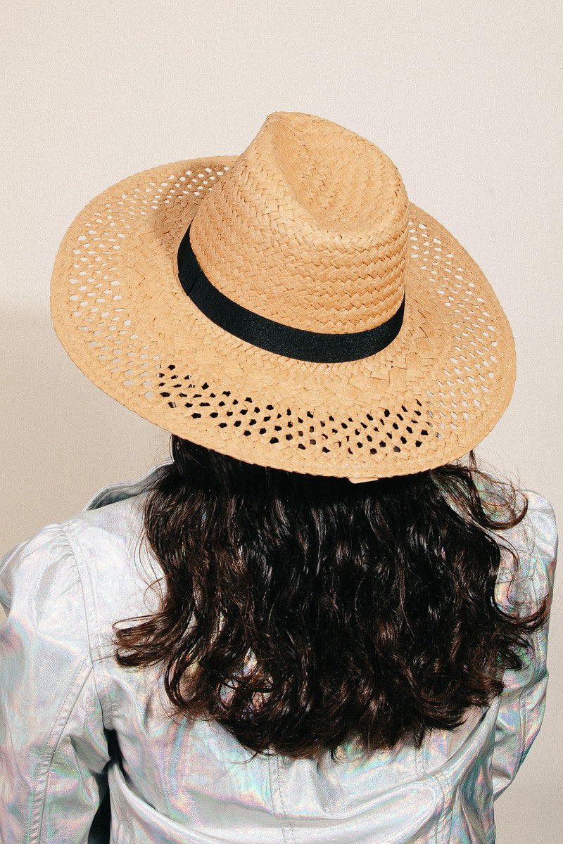 The Fame Basket Weave Straw Sun Hat, featuring a black band and ideal as a fashion accessory, is showcased on a clear stand against a white background.