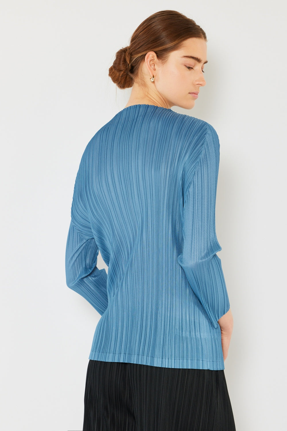 A person wearing the Marina West Swim Pleated Long Sleeve Boatneck Top with matching pants stands against a plain background.