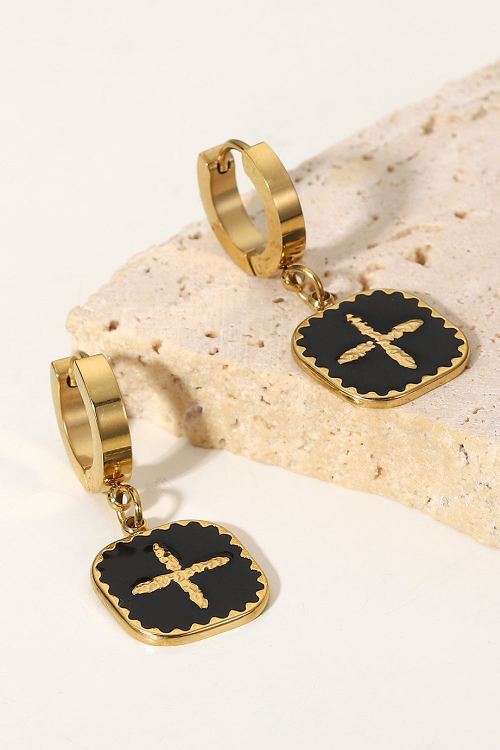 The Plus Sign Square Shape Drop Earrings are a pair of gold hoop earrings featuring square black pendants with a stylish gold plus sign design in the center, crafted from durable stainless steel jewelry.