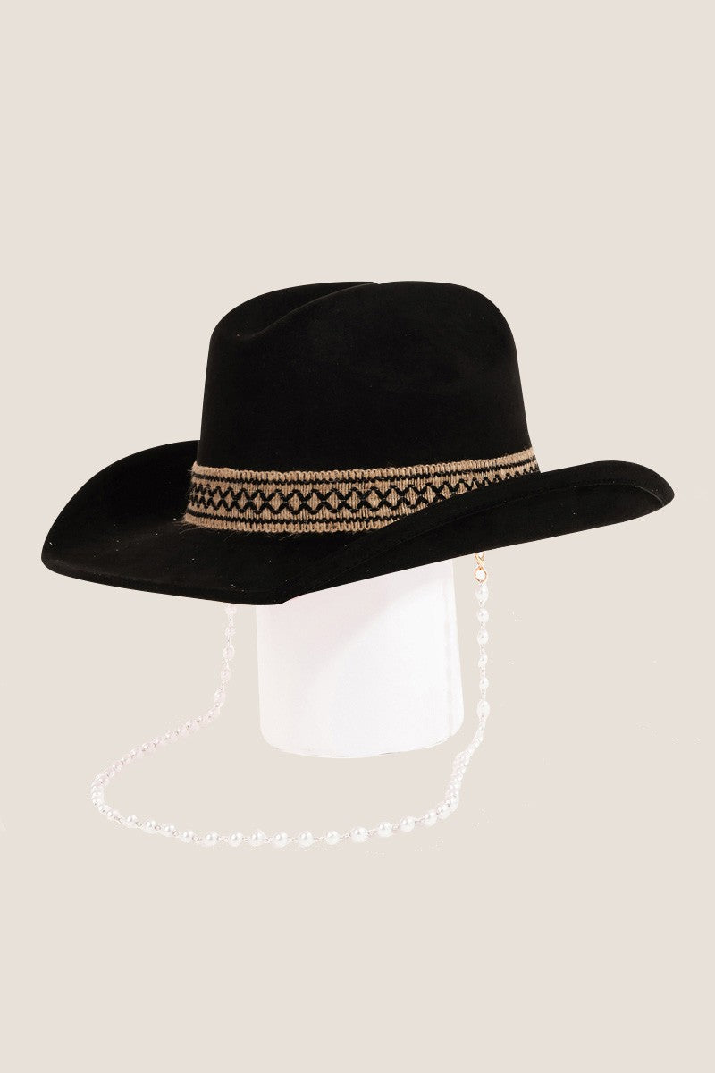 Fame Ornate Band Cowboy Hat in light pink features an intricate band around the crown and a pearl chain elegantly draped from the side, offering a distinctive look.