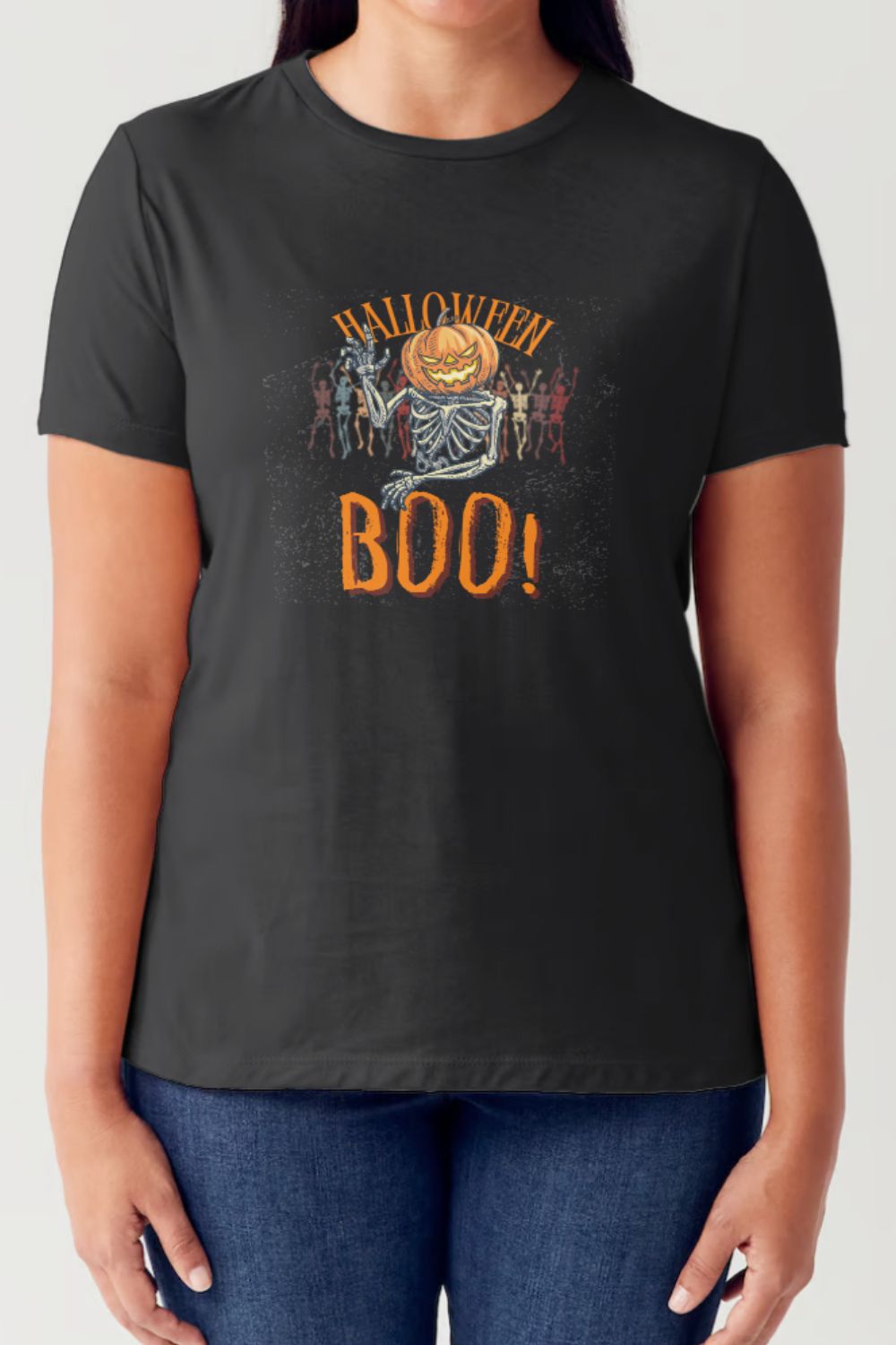 A person wearing a Simply Love Full Size Pumpkin Skeleton Graphic Short Sleeve Tubular T-Shirt, which features a festive Halloween design with a pumpkin, skeletons, and the text "Halloween BOO!".