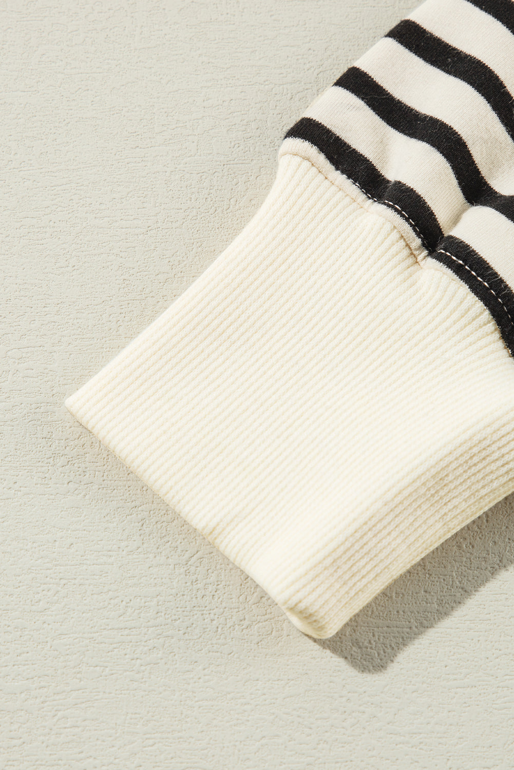 A person with long hair is facing away, wearing a Black Stripe CIAO AMORE Graphic Buttoned Pullover Sweatshirt and a black skirt in an indoor setting. The shirt subtly whispers "CIAO AMORE.