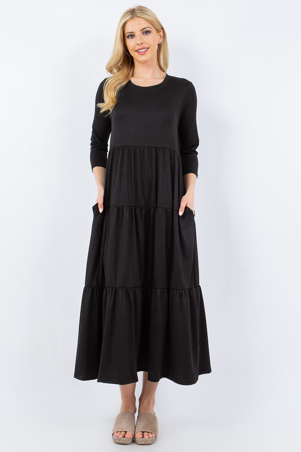 A person wearing the Celeste Full Size Tiered Midi Dress with pockets stands against a neutral background.