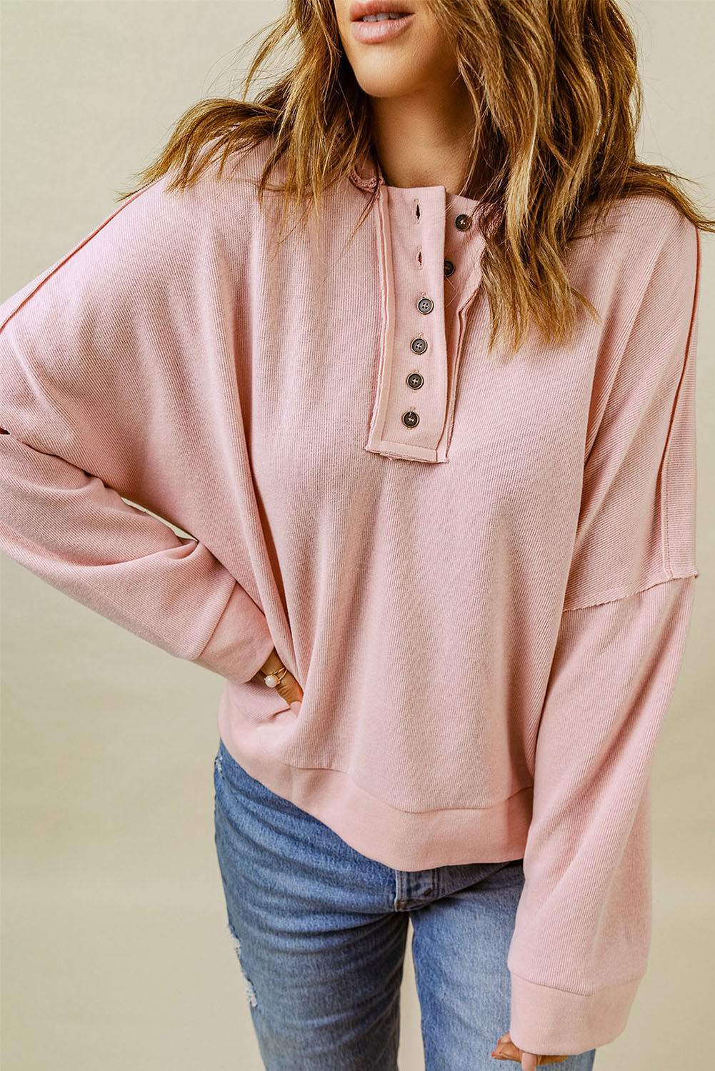 Person with wavy hair wearing a Pink Casual Button Solid Patchwork Trim Hoodie and blue jeans, photographed from the back against a plain background, showcasing fall and winter comfortableness.