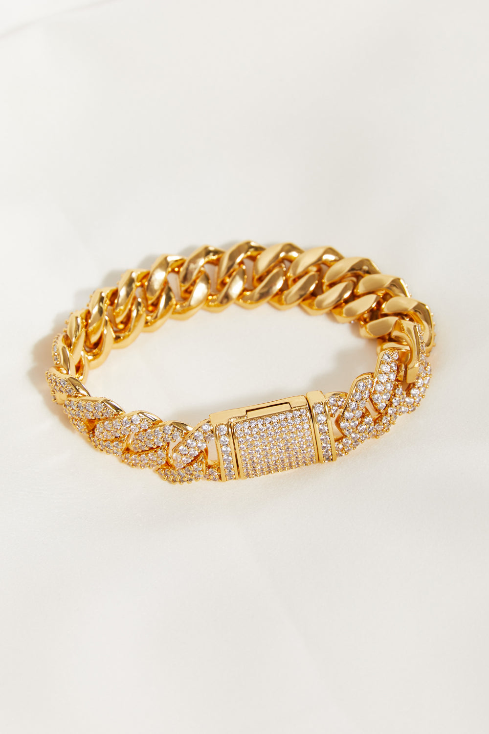 The Alloy Inlaid Zircon Bracelet sits gracefully on a light surface, shimmering with elegance. The intricate design is enhanced by gold-plated details, adding an extra layer of sophistication to this already luxurious piece.