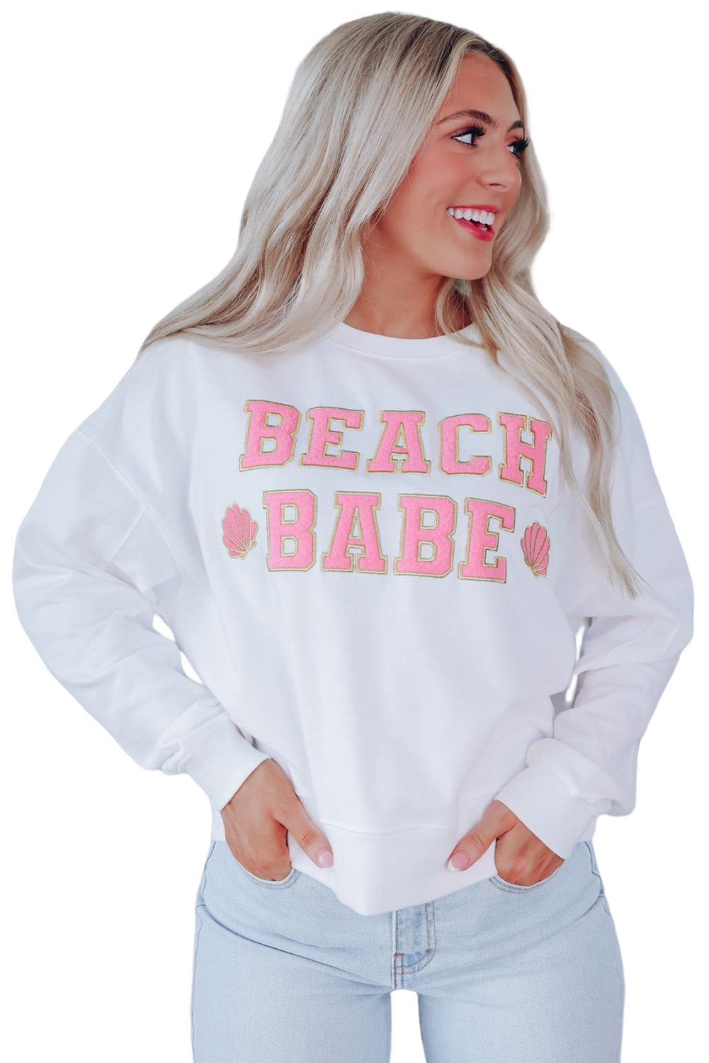 A person with long blonde hair is standing with their back to the camera, wearing a White BEACH BABE Slogan Graphic Casual Sweatshirt and light blue jeans.