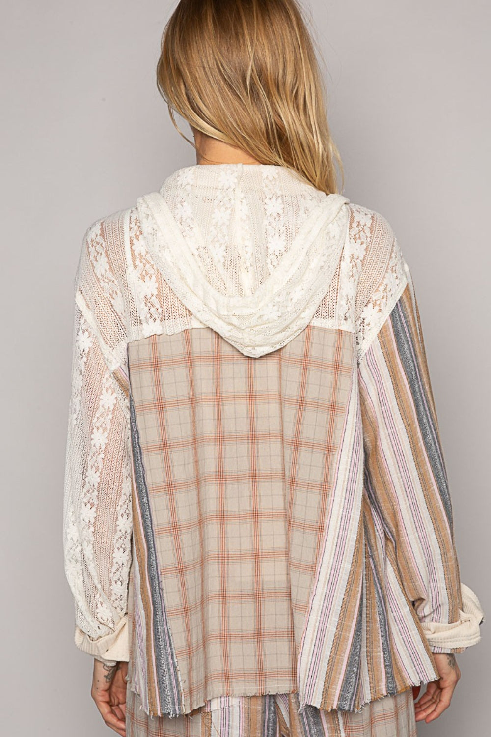 A person with long blonde hair, dressed in a mixed-patterned ensemble featuring 100% cotton lace and plaid elements, looks over their shoulder while holding the drawstring of the POL Long Sleeve Plaid Hood Shirt.