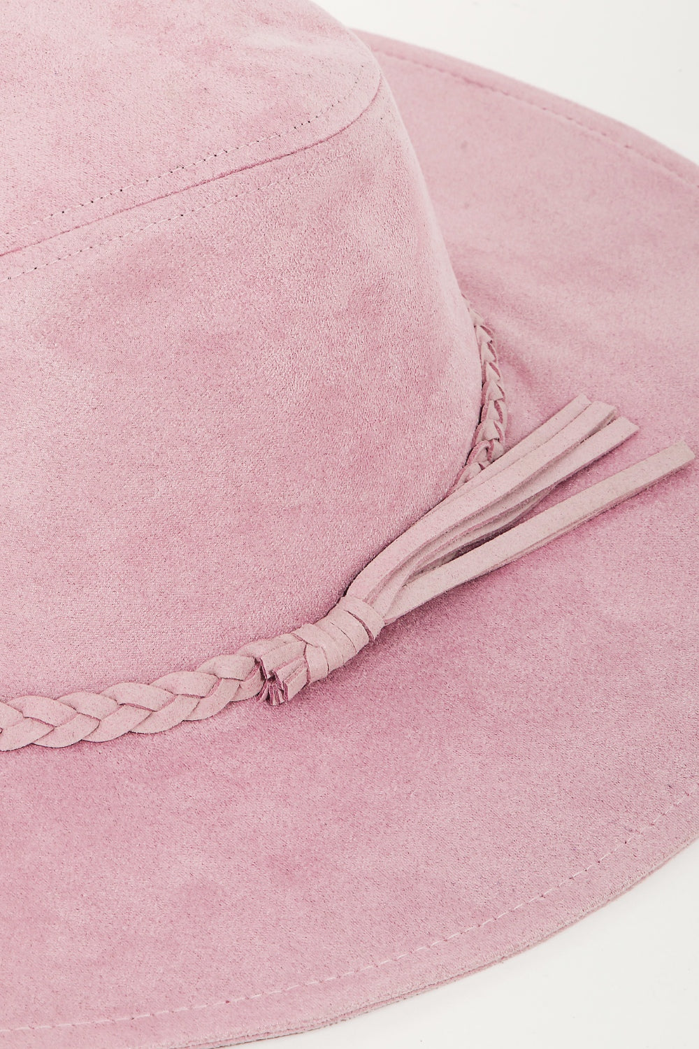 The stylish Fame Braided Faux Suede Hat in a fashionable pink color features a wide brim with a braided band and bow detail, and is displayed on a plain background.