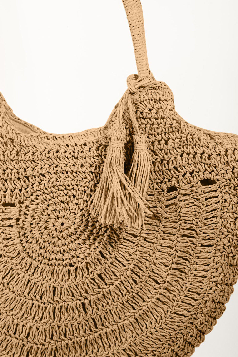 The Fame Straw Braided Tote Bag with Tassel, a woven straw handbag in a semi-circular shape featuring a braided handle and a decorative tassel, exudes Bohemian flair.