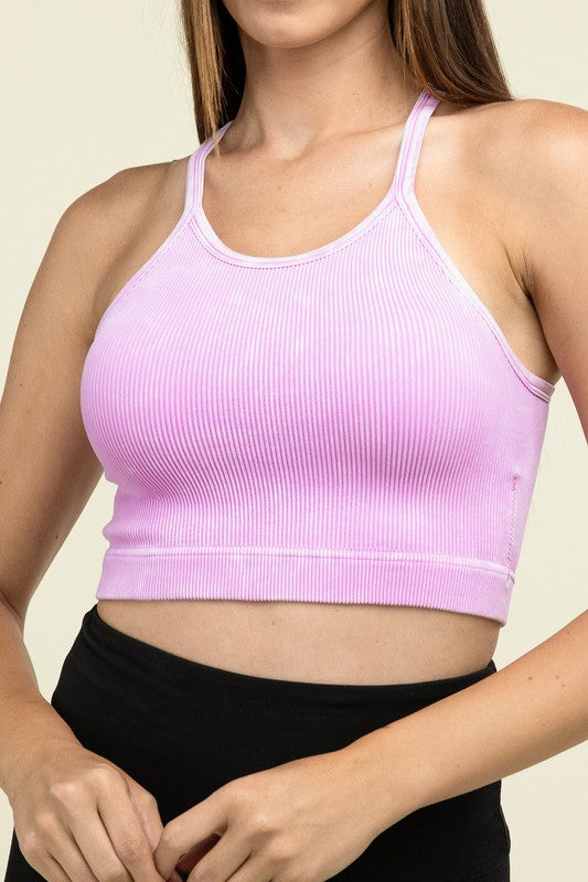 A person poses in a Washed Ribbed Seamless Cropped Cami Top with removable bra pads and black leggings against a neutral background.