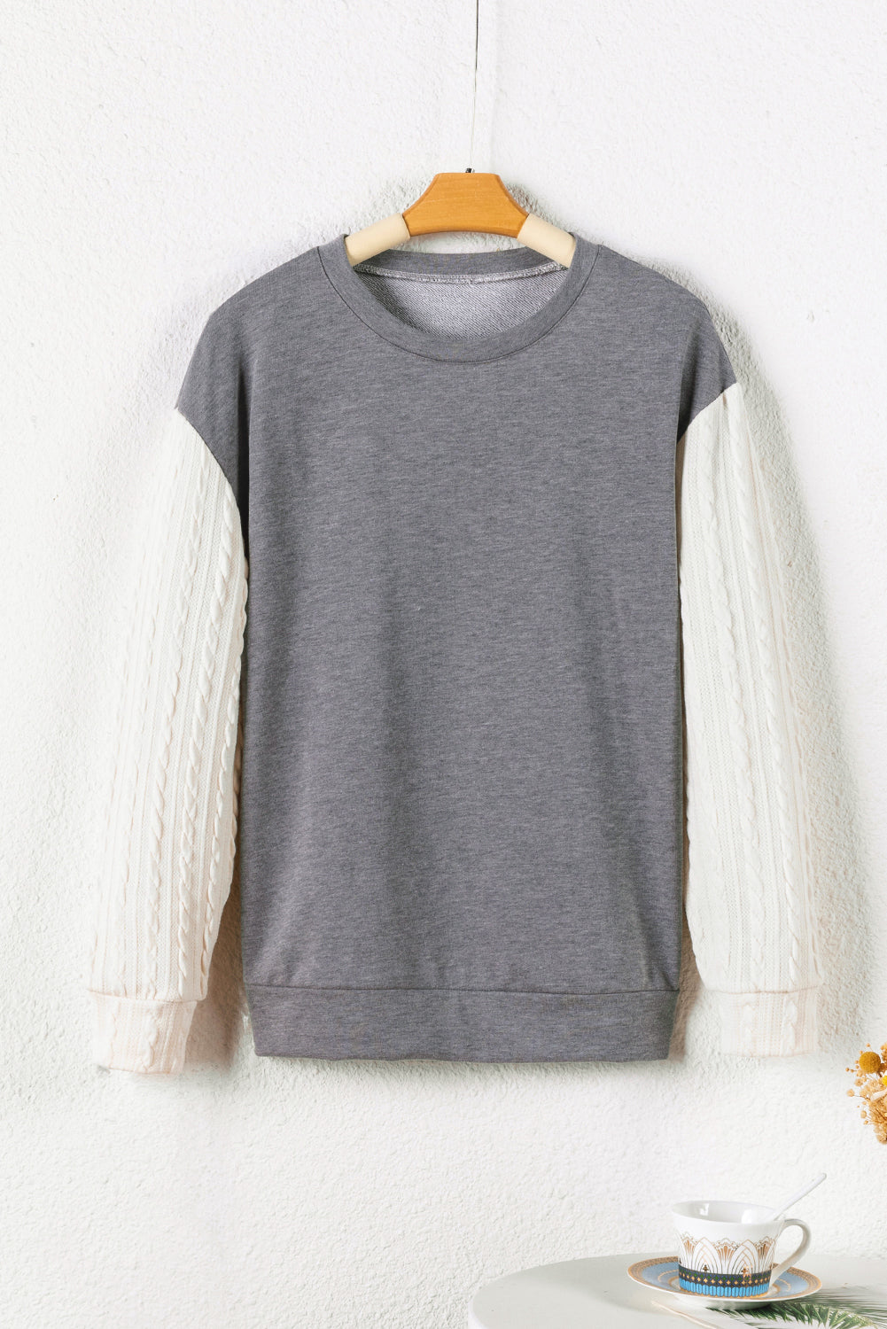 A person wearing a Dark Grey Cable Knit Sleeves Crew Neck Sweatshirt and a gold chain necklace is shown from the shoulders to the waist, standing outdoors.