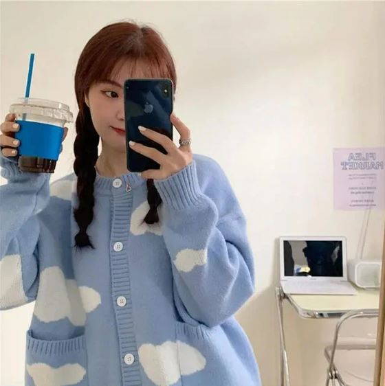 A person in a Kawaii Knitted Clouds Sweatshirt takes a selfie, obscuring their face with a smartphone, featuring Asian size.