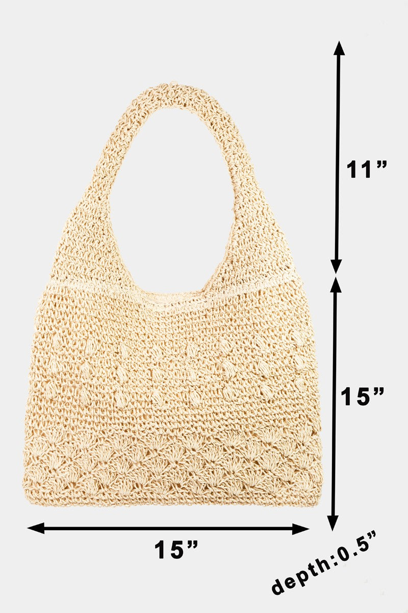 The Fame Straw Braided Tote Bag, featuring a simple pattern and single strap, is displayed against a plain background, exuding a chic and summery bohemian flair.