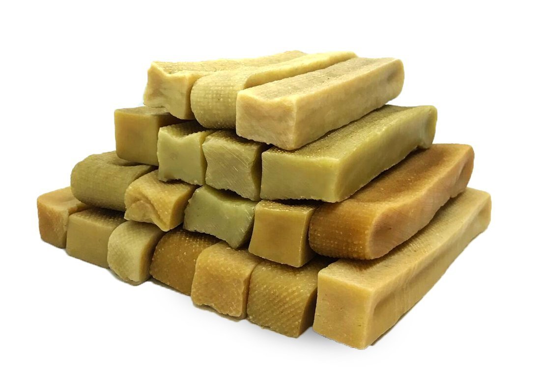 Packaging of Gold Yak Chews for Large Dogs with a stack of Himalayan Yak Milk chews beside it.