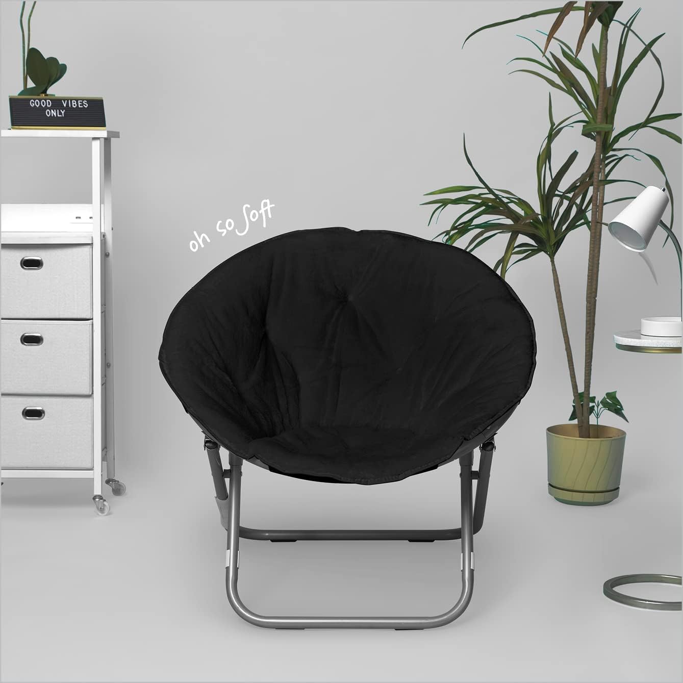 A black, round, collapsible Faux Fur Saucer Chair with a soft cushioned seat and a metallic frame.