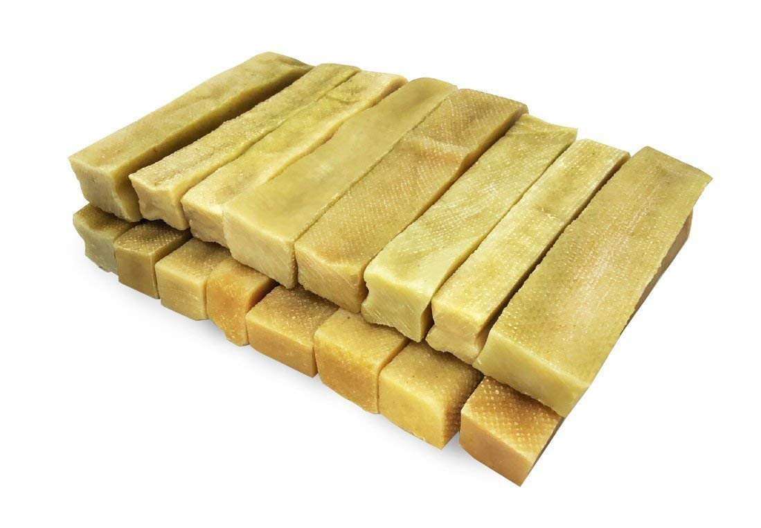 Packaging of Gold Yak Chews for Large Dogs with a stack of Himalayan Yak Milk chews beside it.