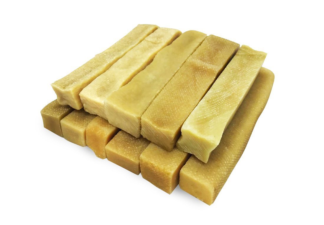 Packaging of Gold Yak Chews for Large Dogs with a stack of Himalayan Yak Milk chews beside it.