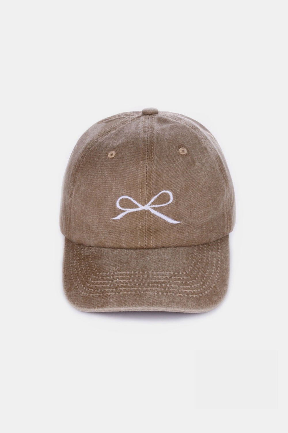 The Zenana Bow Embroidered Washed Cotton Cap features a pink design with a stylish white bow on the front, set against a plain, light background. This chic accessory seamlessly combines elegance and sportiness.