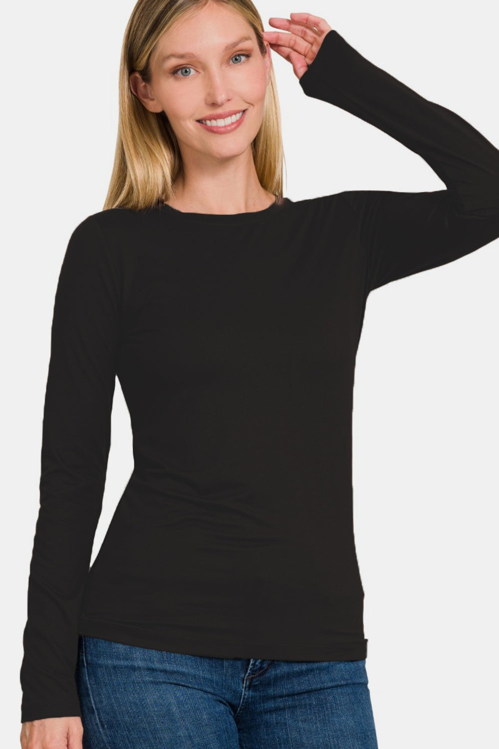 A woman in a sleek black dress, echoing the refined elegance of the Zenana Full Size Brushed Microfiber Long Sleeve Round Neck T-Shirt.