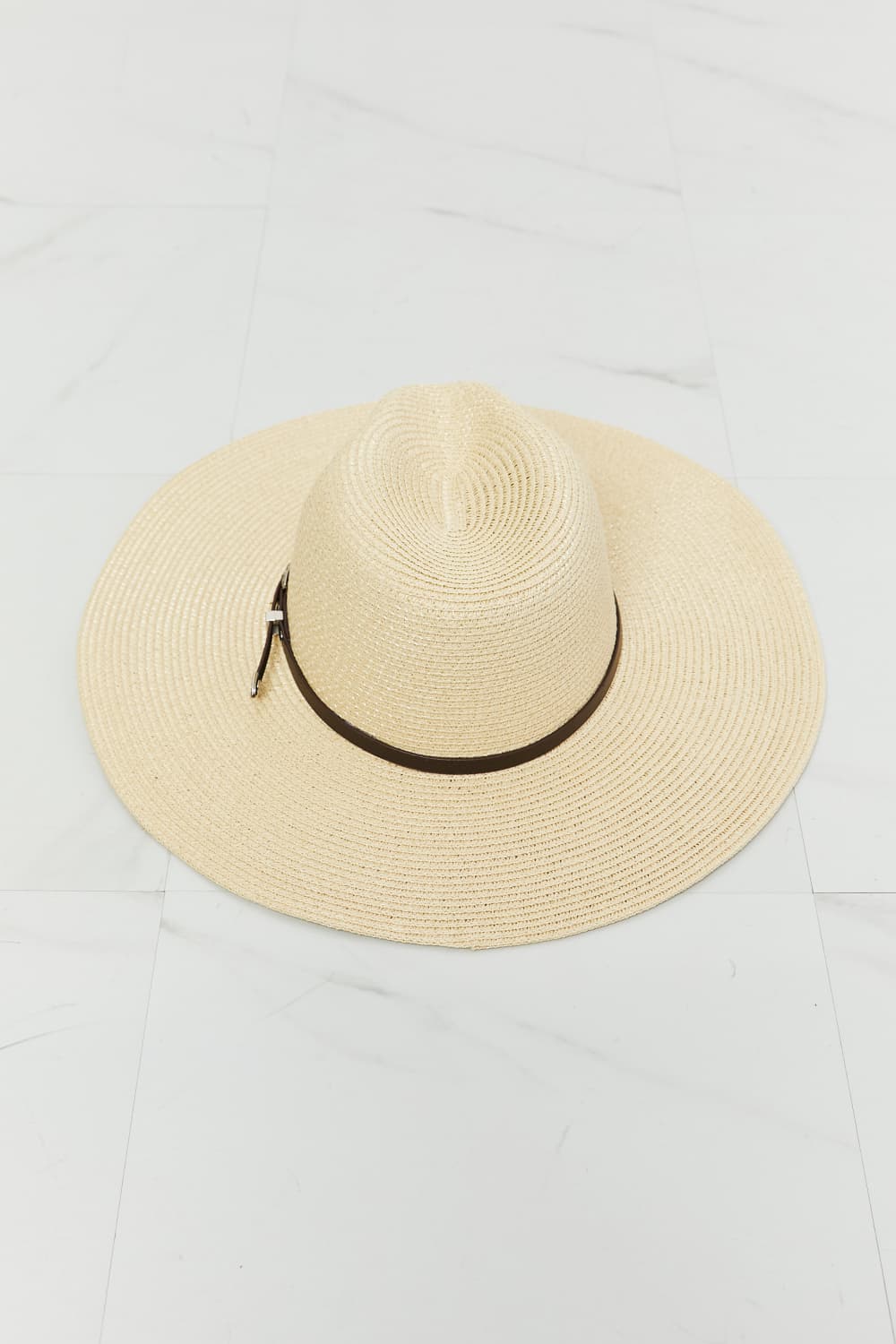 A woman wearing a light-colored tank top and a Fame Boho Summer Straw Fedora Hat with a brown band, smiling and facing slightly to the right.