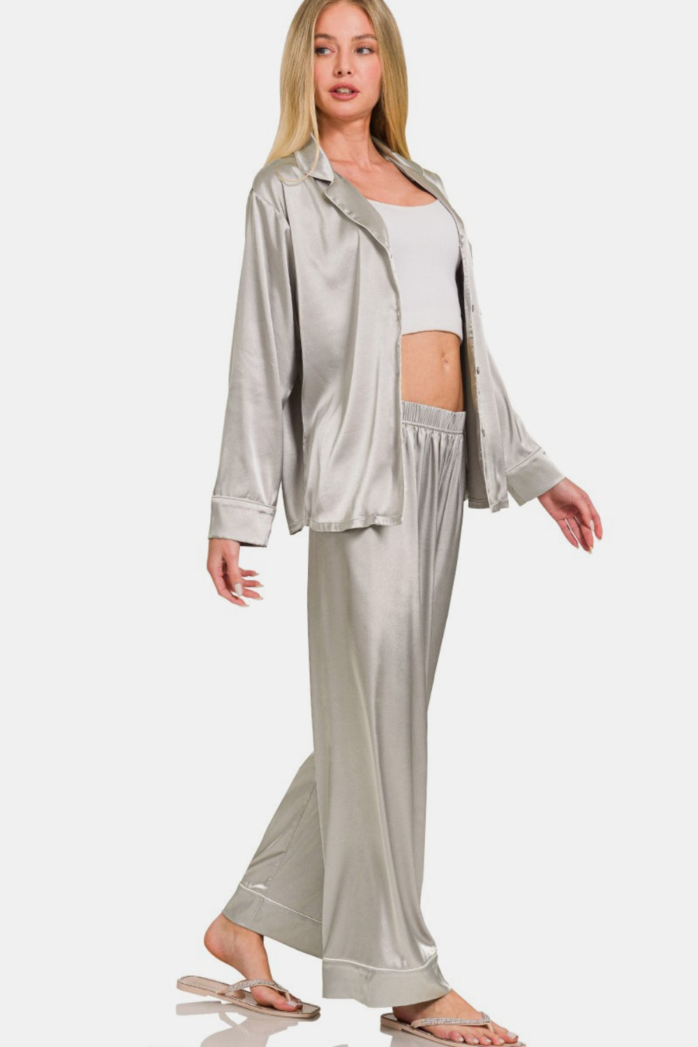 A person wearing the Zenana Satin Long Sleeve Shirt and Pants Pajama Set stands against a plain background.