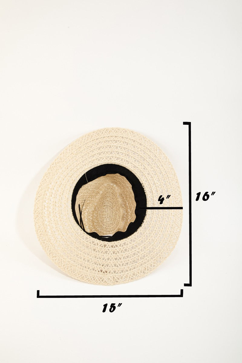 The Fame Wide Brim Straw Weave Sun Hat is designed with a wide brim and adorned with a black ribbon band, providing both stylish flair and superior sun protection.