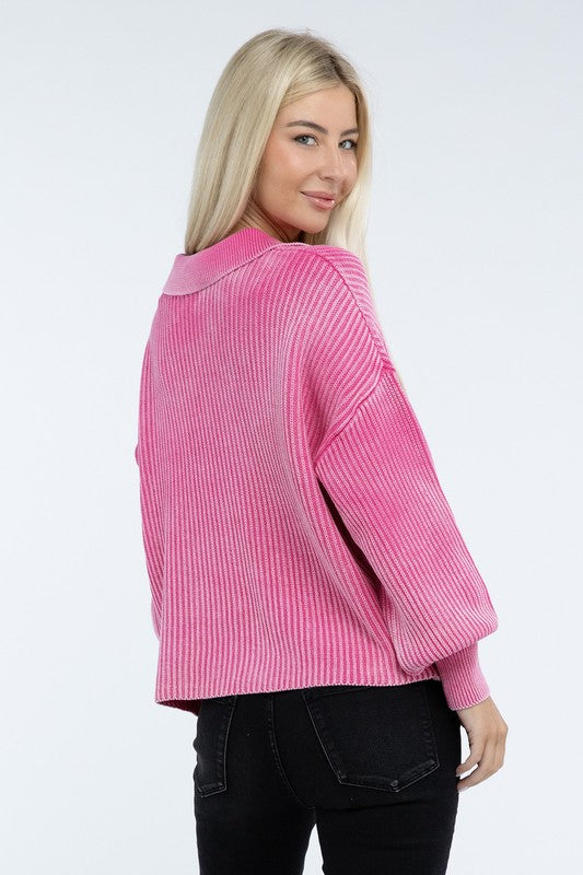 A woman with long blonde hair is wearing the Washed Collared Henley Sweater in pink and black pants, smiling at the camera.